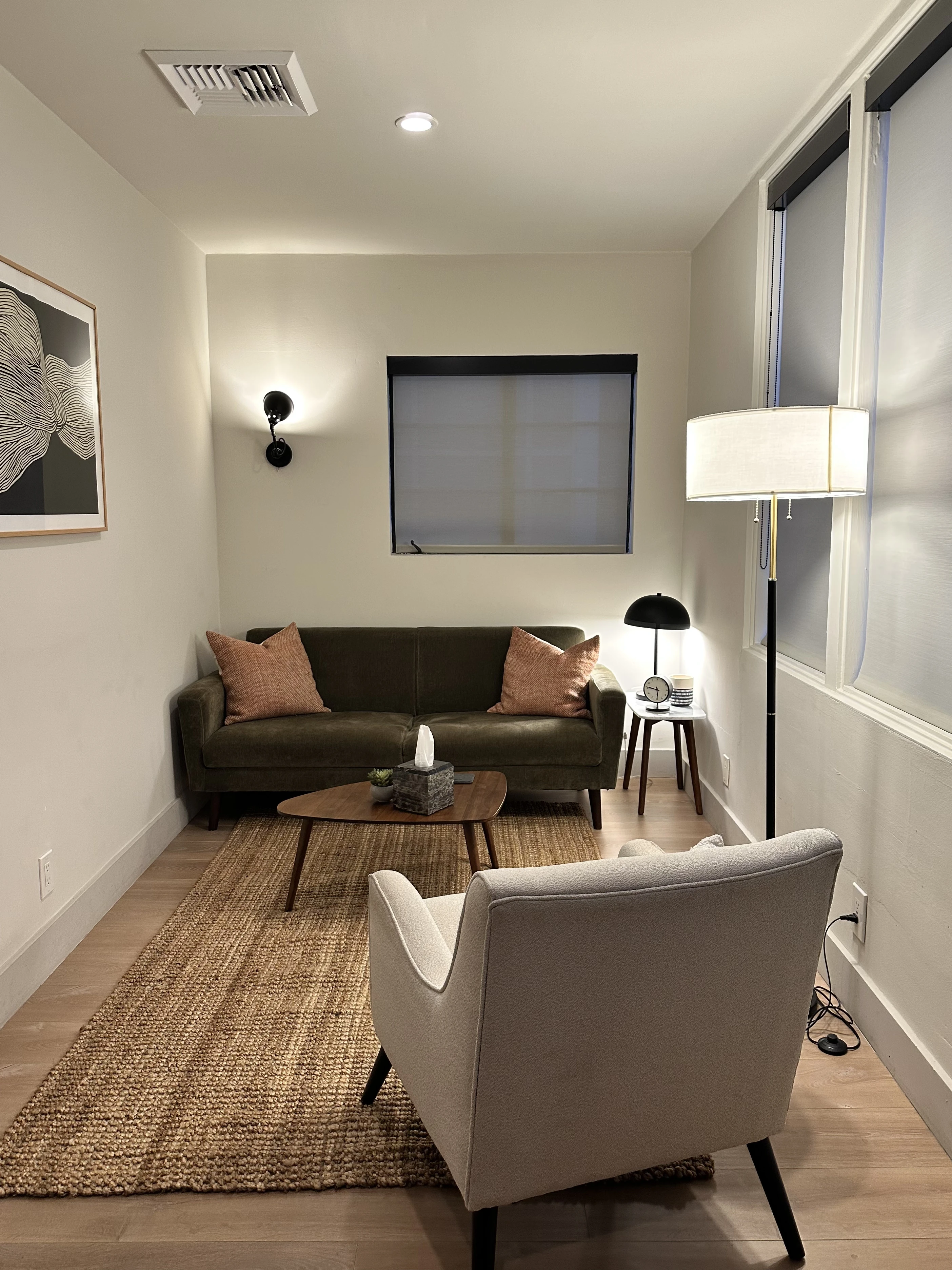 Warm therapy office — comfortable couch, warm lighting, welcoming space